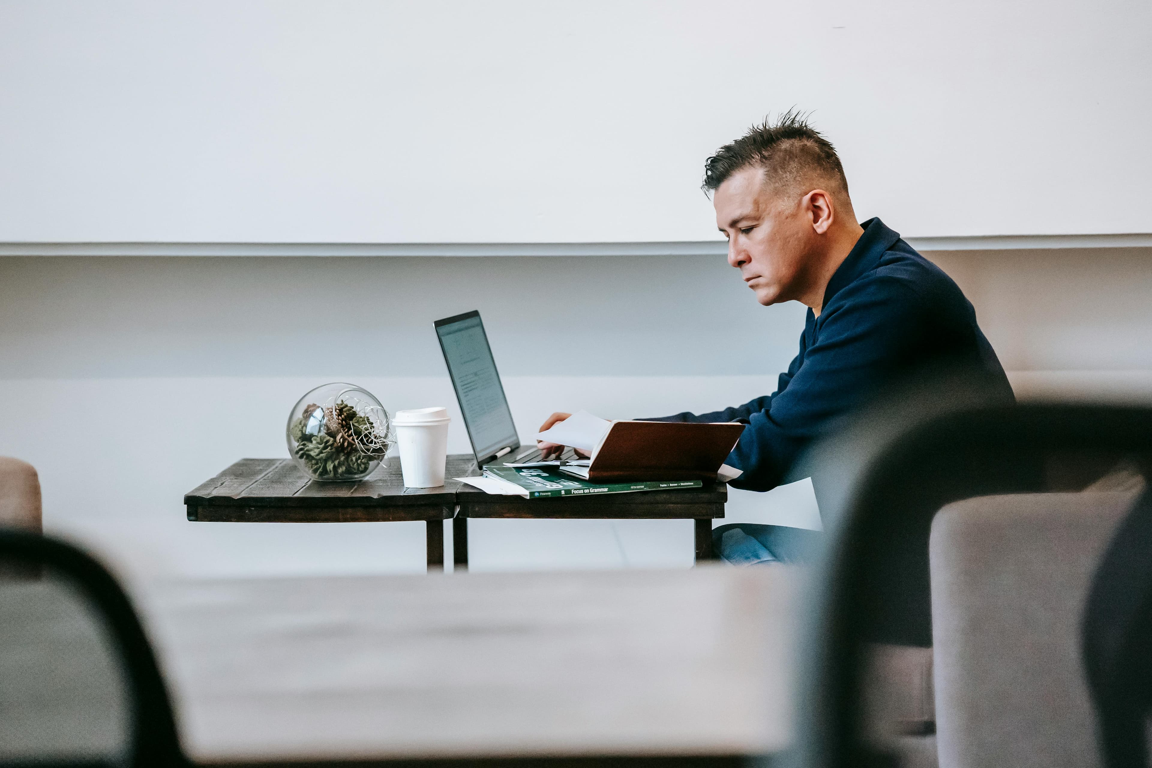 A founder working with notes and a laptop